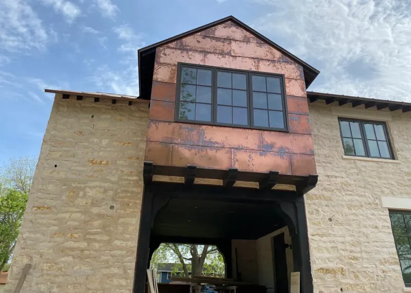 Copper metal panel facade on a stone building for Skylight Installation in Okeechobee