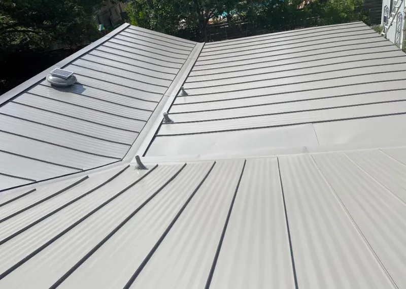 Solar attic fan installed on a metal roof for Roof Ventilation in Okeechobee